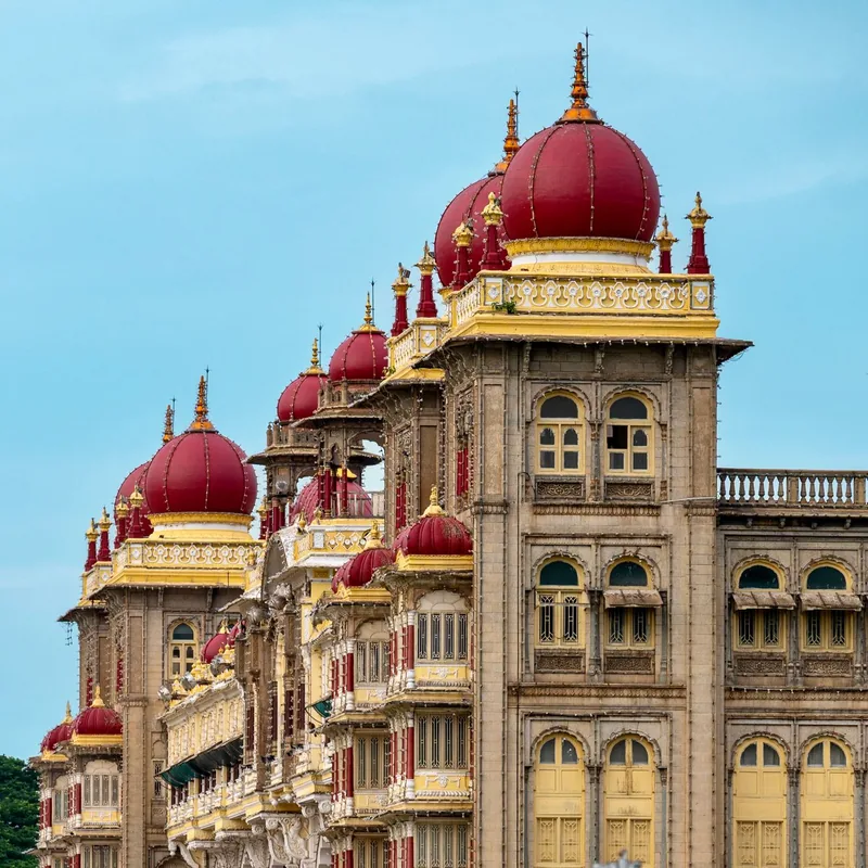 The grand Mysore Palace lit against the evening sky